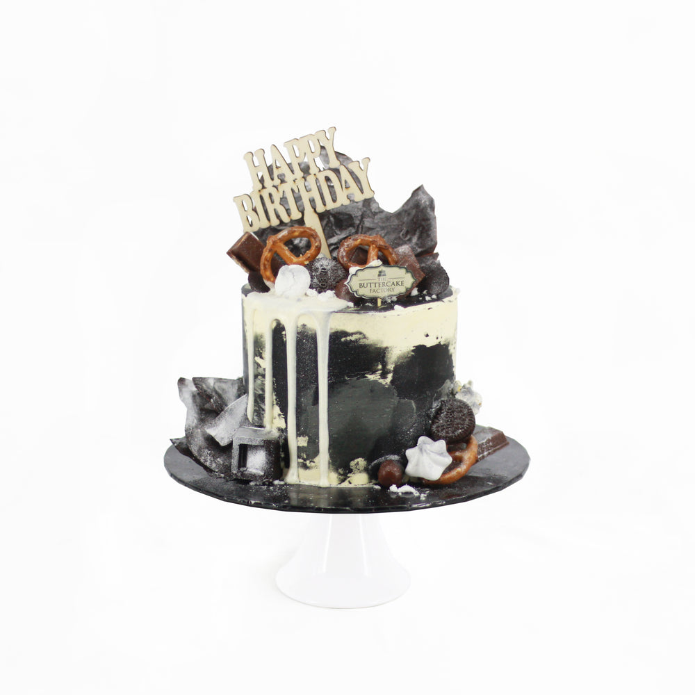 Chocolate cake with black and white buttercream, topped with white glaze