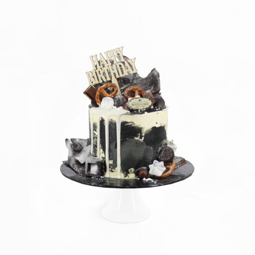 Chocolate cake with black and white buttercream, topped with white glaze