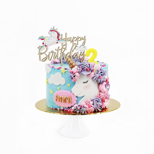 Pretty unicorn cake with blue buttercream, with a fondant unicorn with purple and pink mane
