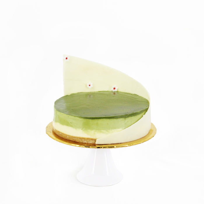 Matcha cheese cake with a white chocolate decoration
