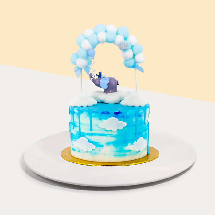 Gender reveal baby boy cake with an elephant figurine