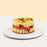 Sponge cake fenced with sponge fingers, topped with fresh fruits