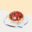 Basque burnt cheesecake, topped with fresh flowers, strawberries and blueberries