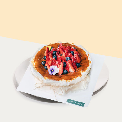 Basque burnt cheesecake, topped with fresh flowers, strawberries and blueberries