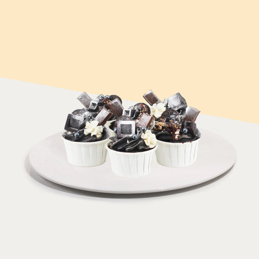 Black buttercream cupcakes, topped with frosted chocolate treats