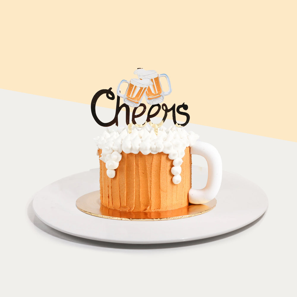 Beer mug cake frosted in brown buttercream on the sides, and white foam made of white buttercream