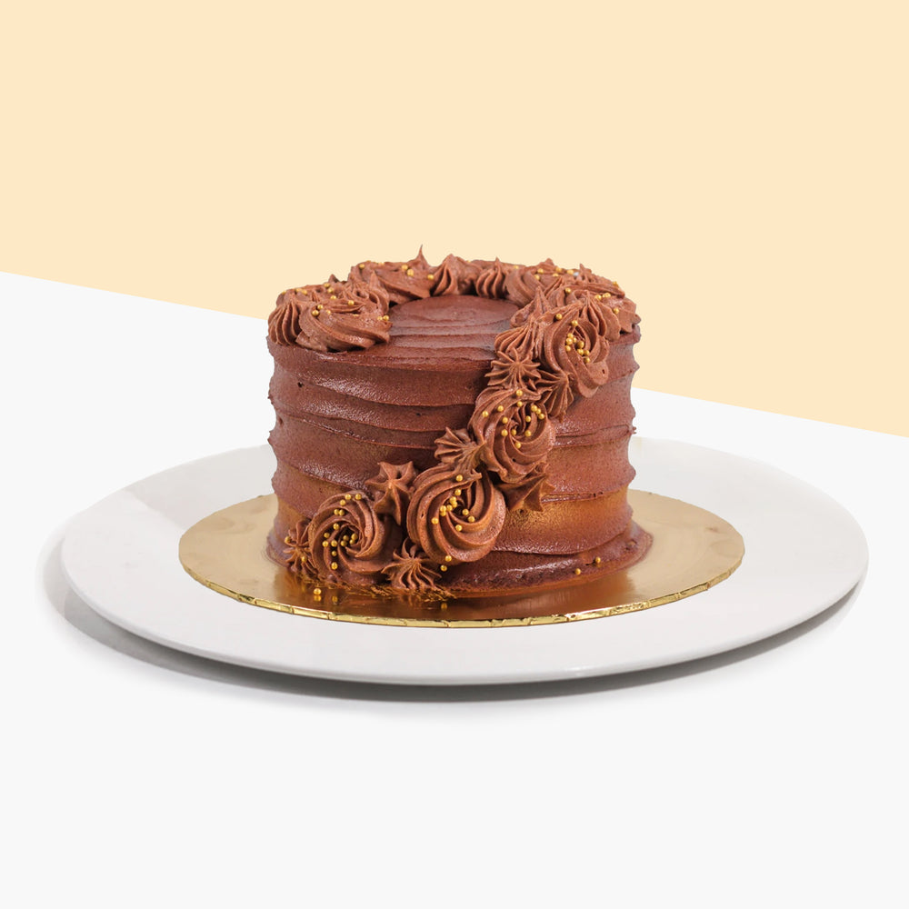 Chocolate coated butter cake, with hand piped chocolate rosettes