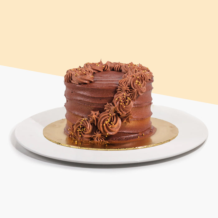 Chocolate coated butter cake, with hand piped chocolate rosettes