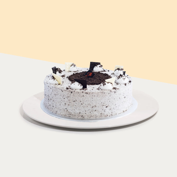 Vanilla sponge cake, coated generously with cookies and fresh cream