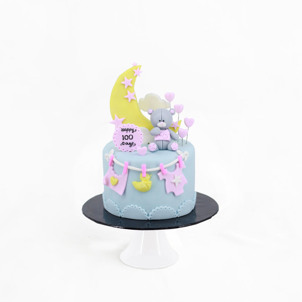 Fondant decorated cake with blue and pink design elements