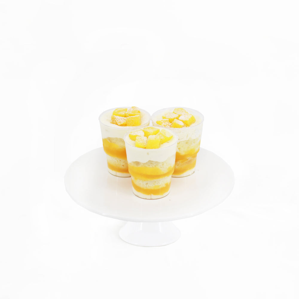 Lemon sponge cake, with low fat Greek yogurt, mango cream, almond flakes and frozen mango cubes