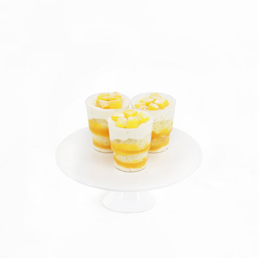 Lemon sponge cake, with low fat Greek yogurt, mango cream, almond flakes and frozen mango cubes