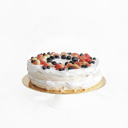Giant meringue with fresh cream, fresh strawberries and blueberries