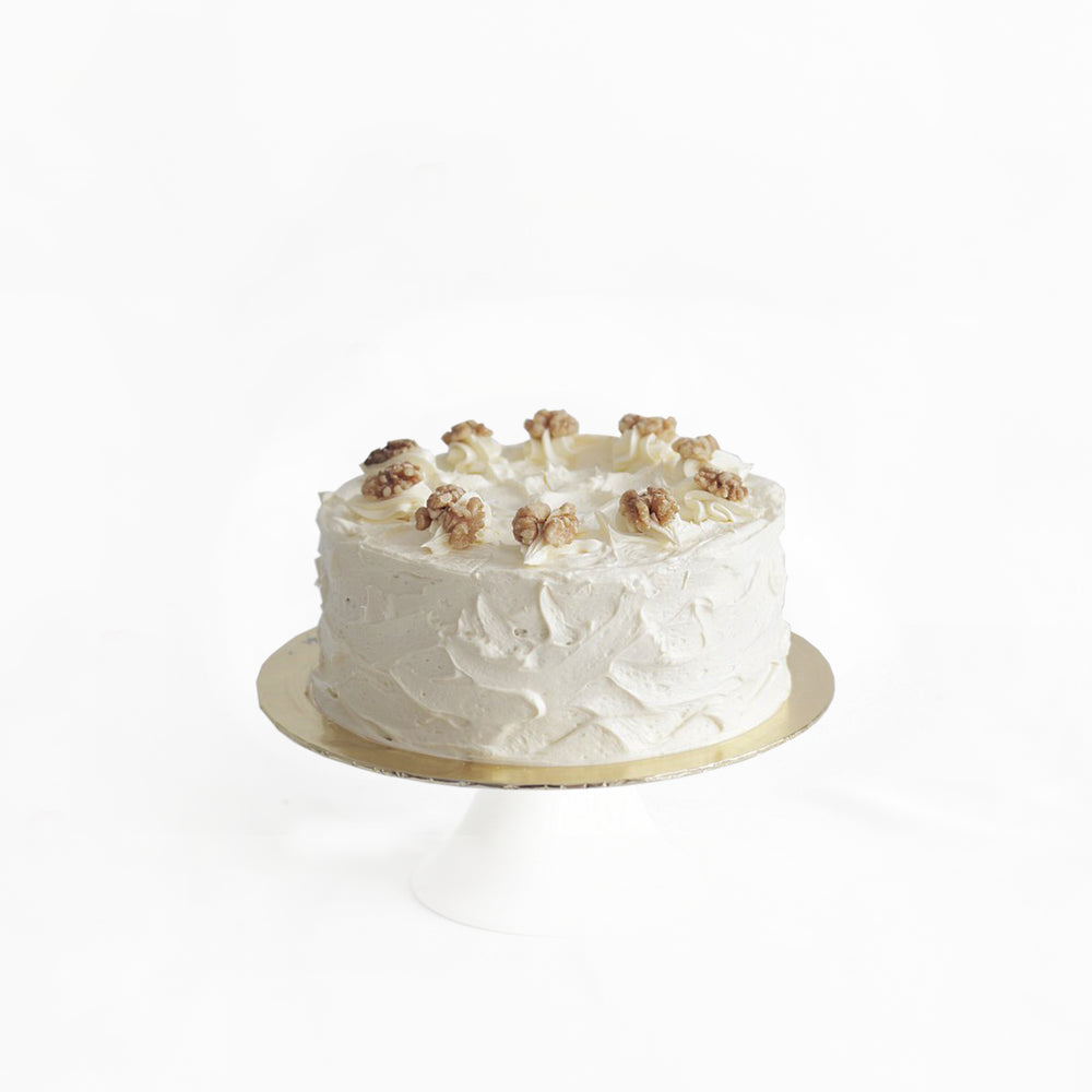 Moist orange and cinnamon cake, filled with carrot shreds, frosted with cream cheese