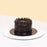 Mini chocolate cake coated head to toe with smooth chocolate cream, decorated with chocolate swirls