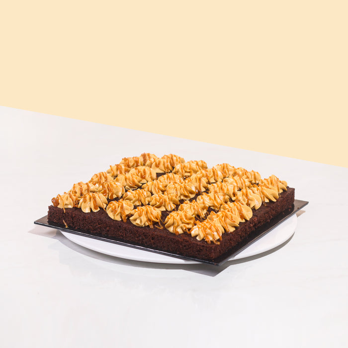 Chocolate cake bites with salted caramel cream, coated with salted caramel drizzle