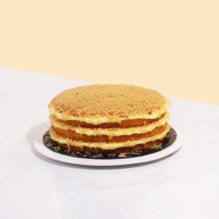 Butter cake layered with butterscotch spread, topped off with cookie crumbs and a generous drizzle of butterscotch sauce.