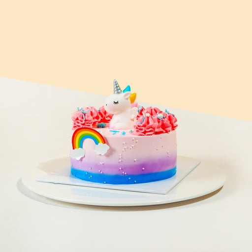 Ombre gradient buttercream cake, with a cute unicorn topper