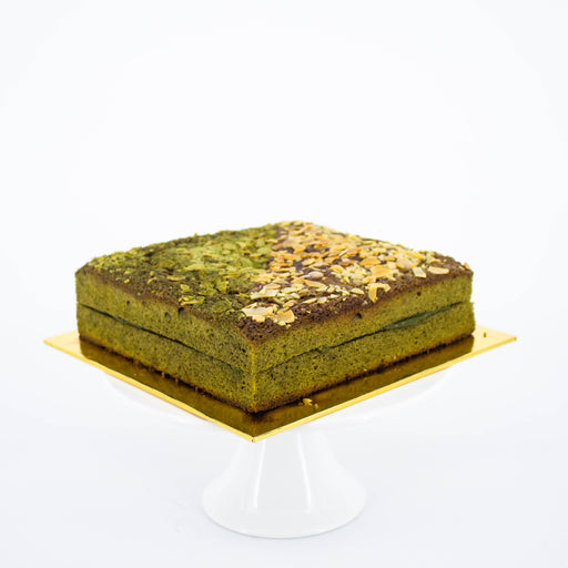 Fudgy matcha brownies with white chocolate matcha ganache topped with almond slices