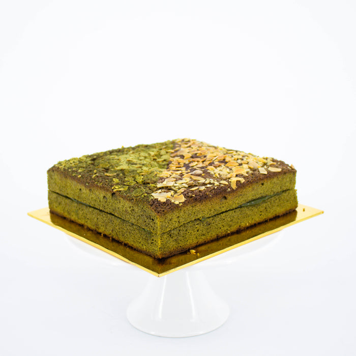 Fudgy matcha brownies with white chocolate matcha ganache topped with almond slices