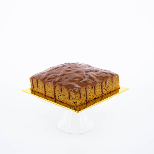 Coffee cake embedded with walnuts, glazed in caramel sauce