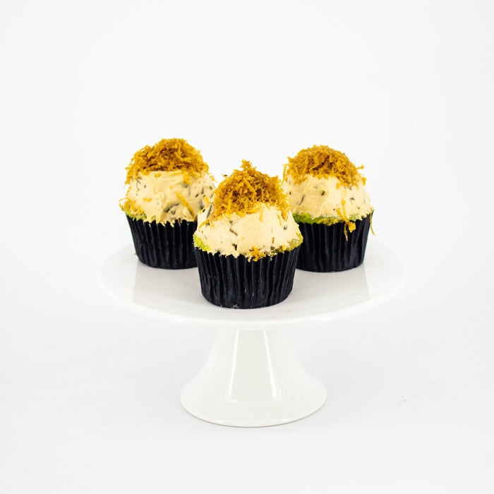 Pandan cupcakes, frosted with cendol and coconut milk cream, topped with shredded coconut flakes infused with gula melaka
