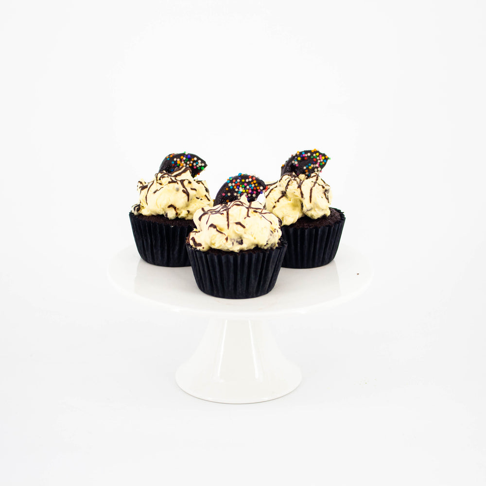 Chocolate sponge cupcakes, frosted with cream cheese and Oreo crumbs