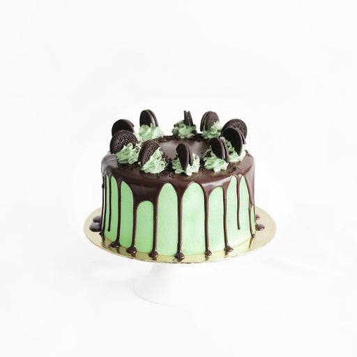 Chocolate cake with mint, topped with chocolate glaze, Oreos and mint cream cheese