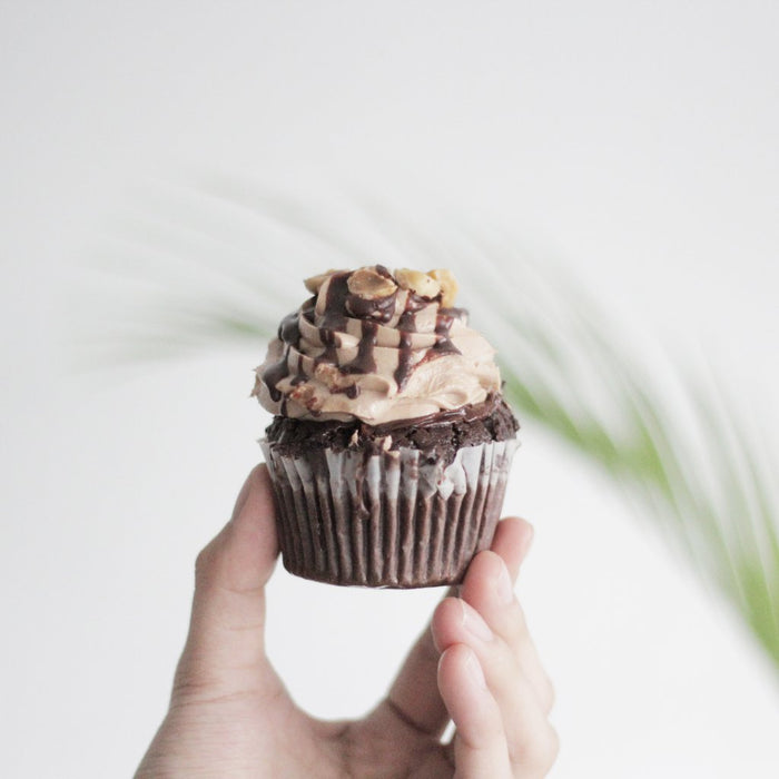 Chocolate hazelnut cupcakes with chocolate cream, and toasted hazelnuts