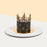 Cake with black buttercream frosting, topped with a crown