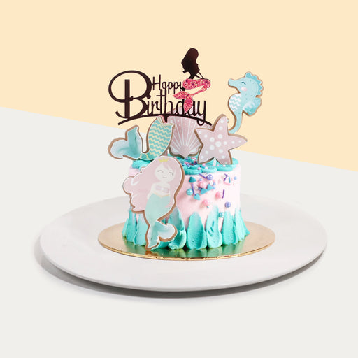 Cake decorated in blue and pink buttercream, decorated in mermaid theme