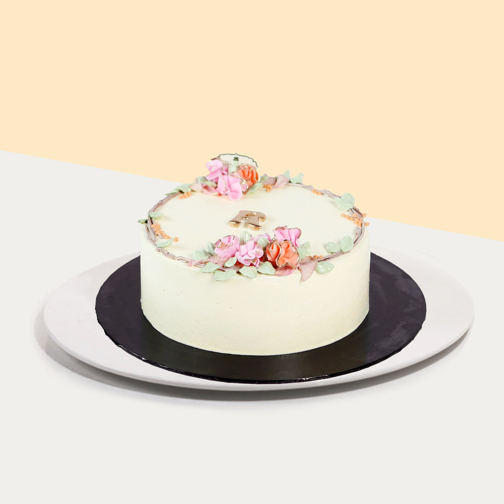 Korean inspired buttercream cake, decorated with hand piped flowers, and an initial of your choice