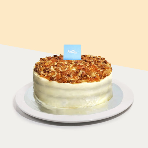 French carrot cake with Greek black currant, layered with German cheese and topped with caramelized nuts