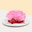 Cake decorated with pink chocolate fondant rose petals, wrapped with a ribbon
