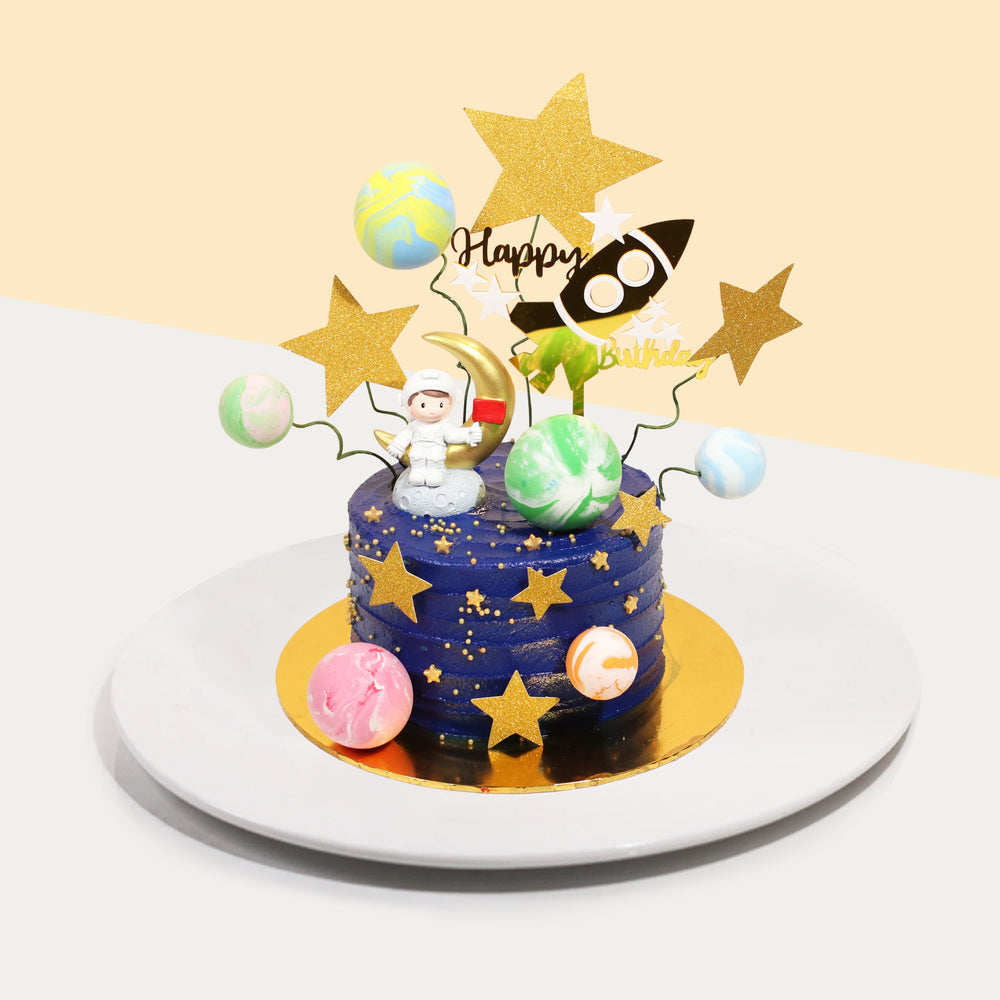 Butter cake decorated with a space theme, covered in blue buttercream