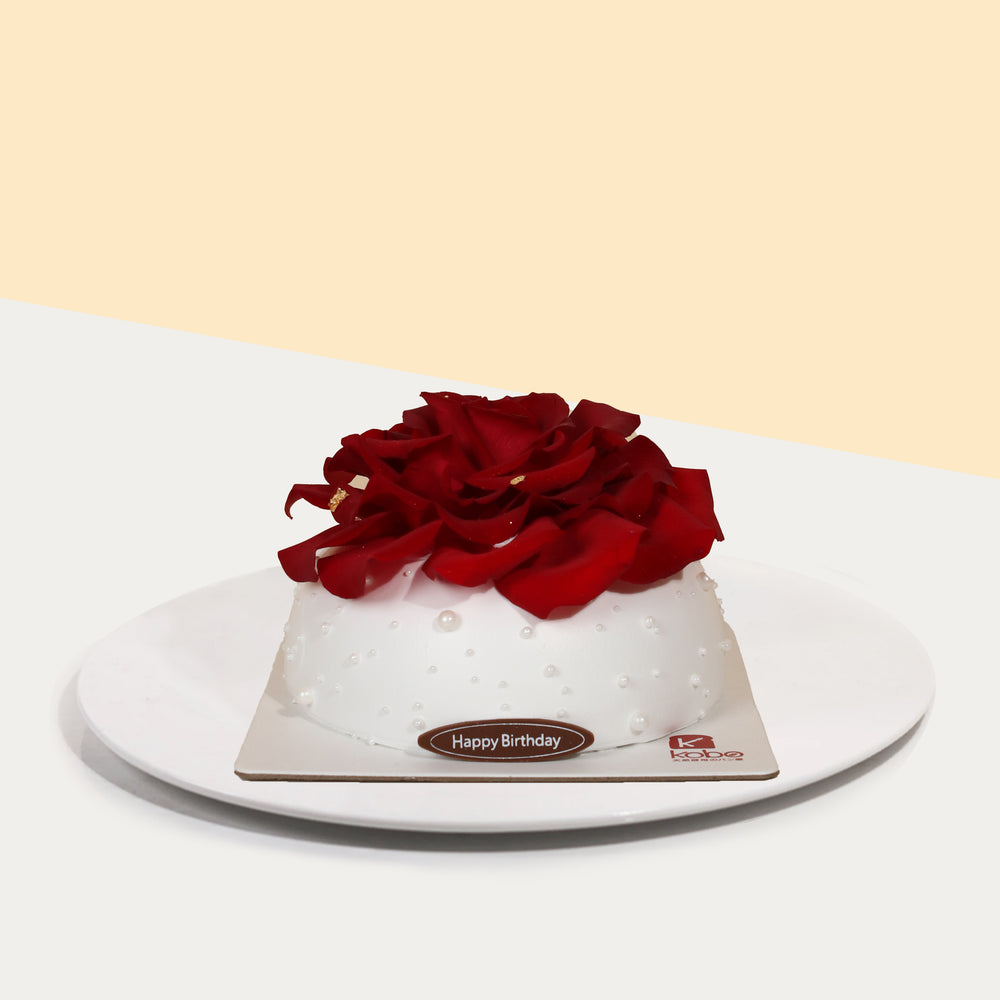Chocolate chiffon cake, layered with Panna Cotta, blue berry filling, and a red rosette