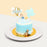 Butter cake frosted in blue buttercream, with a boy on a train figurine
