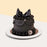 Black chocolate sponge cake, with chocolate cream, black buttercream piping, topped with black fondant ribbon