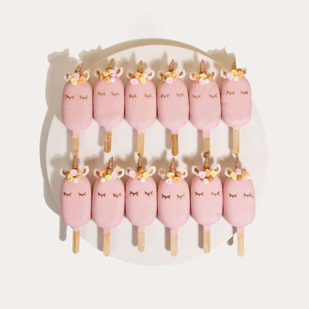 Twelve pieces of pink unicorn cakesicles