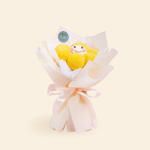 Bouquet with yellow ping pong flowers, with one of them having a smiley face