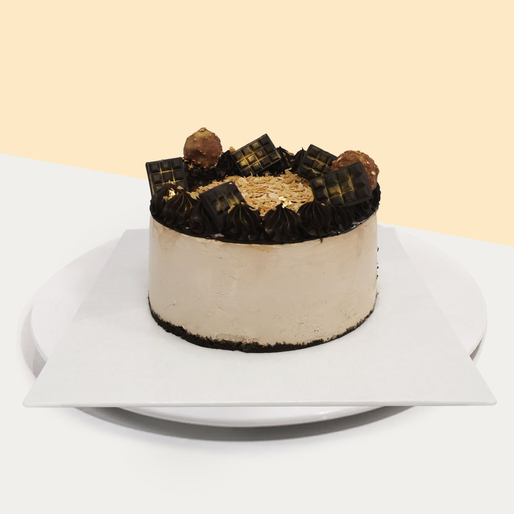 Dark chocolate mousse cake, topped with gold-painted chocolates