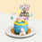 Blue buttercream cake with colorful sprinkles, and a mini cake on top