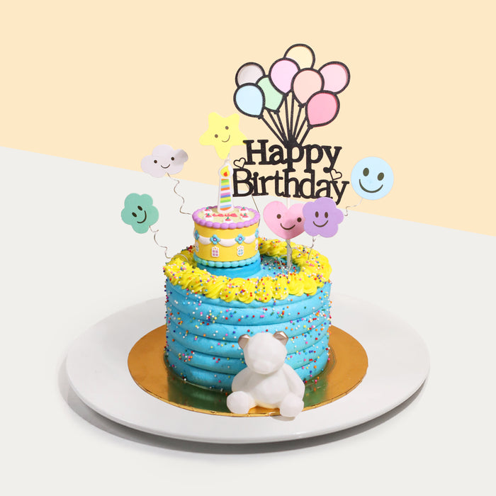 Blue buttercream cake with colorful sprinkles, and a mini cake on top