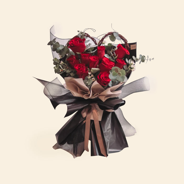 Flower bouquet with Premium Kenya Red Roses, Wax Flower, Eucalyptus, wrapped in black wrapping paper and mesh