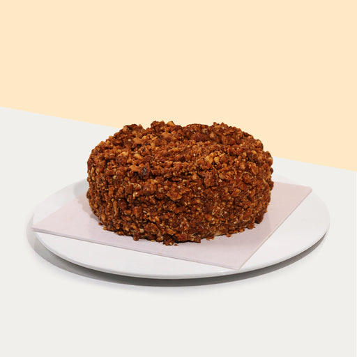 Tiramisu cheese mousse, with lady finger sponge soaked with Kahlua, topped with caramelized nuts