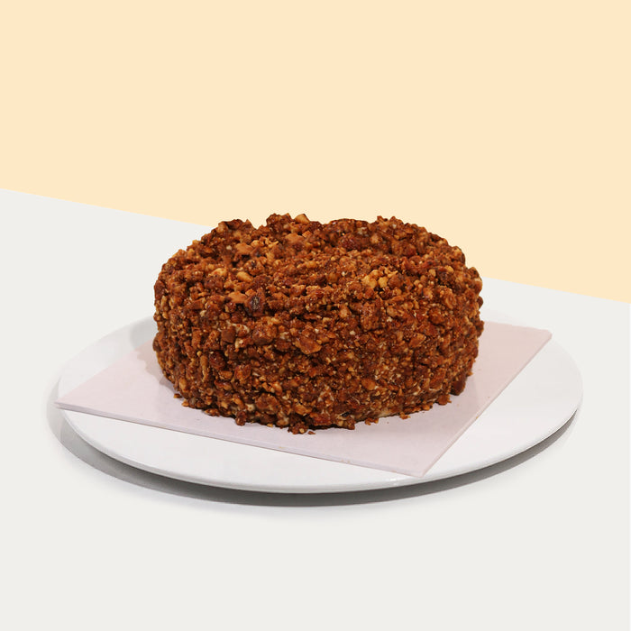 Tiramisu cheese mousse, with lady finger sponge soaked with Kahlua, topped with caramelized nuts