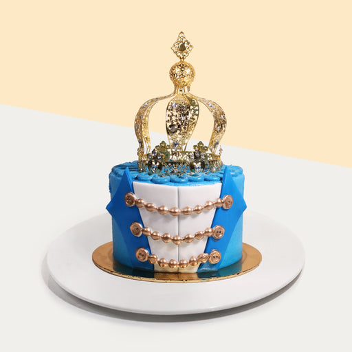 Prince themed cake with fondant decorations, topped with a crown