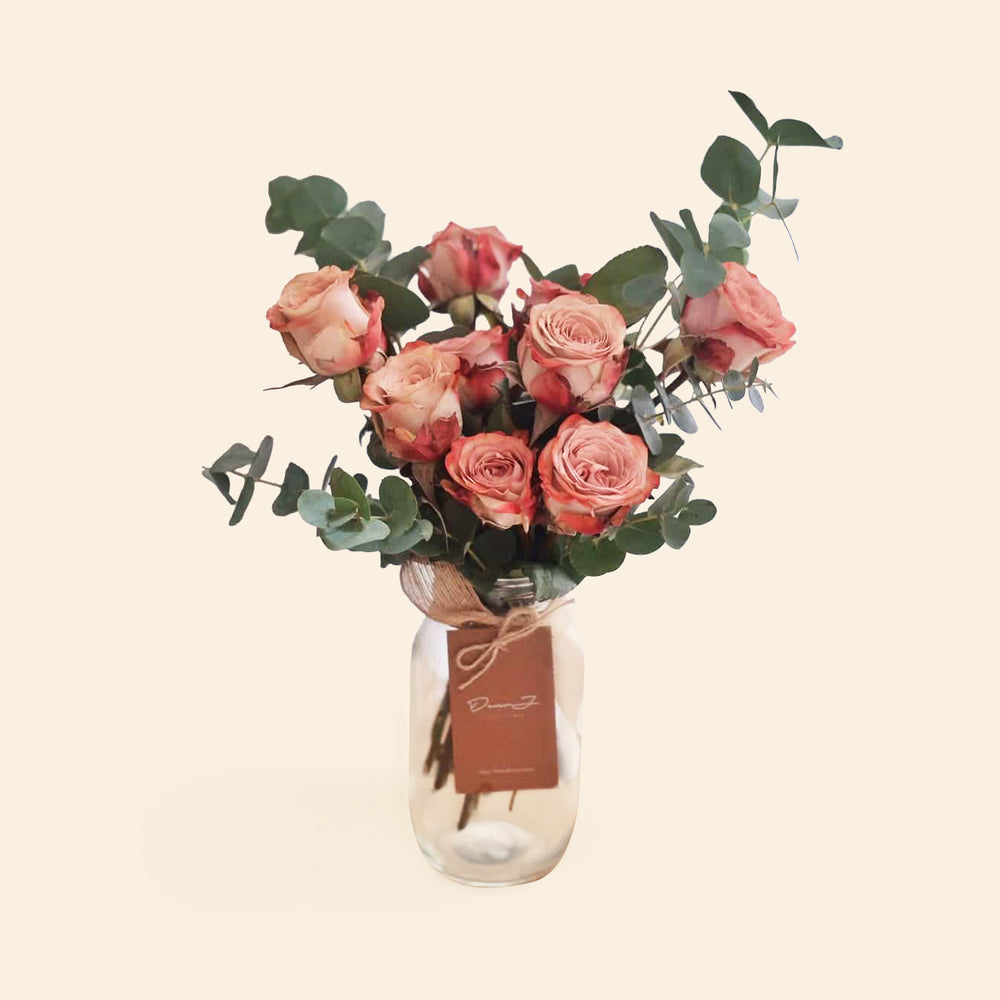 Vintage Kenya Cappuccino roses in a jar with eucalyptus leaves