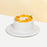 Sponge cake with cream frosting, topped with mangoes and macadamia nuts
