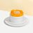Sponge cake frosted in fresh cream, topped with mango slices and longans